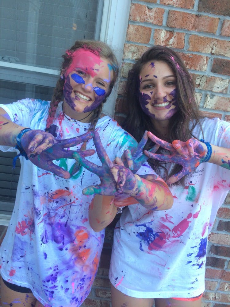 Alpha Chi Omega members display paint splatters.&nbsp;