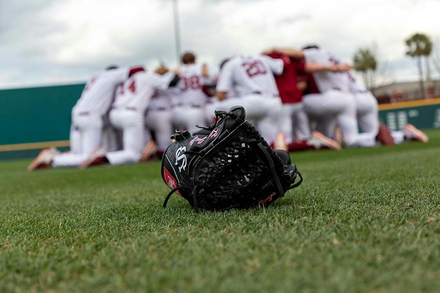 The South Carolina baseball team huddling in the outfield of Founders Park before a game during the 2022 season.&nbsp;