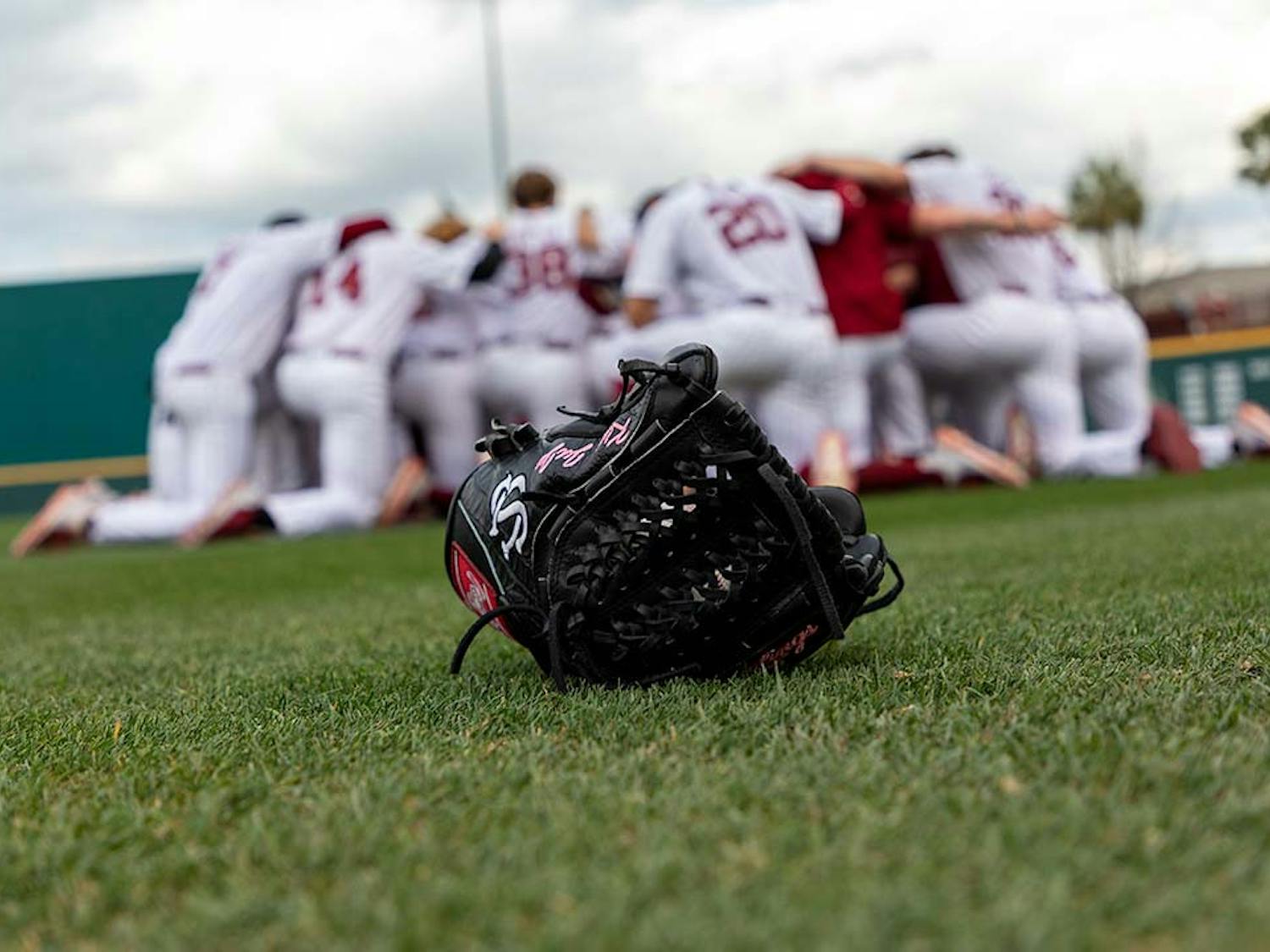 The South Carolina baseball team huddling in the outfield of Founders Park before a game during the 2022 season. 