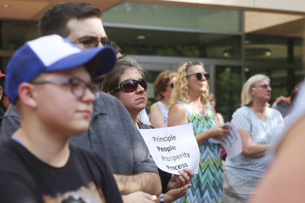 A supporter holds a sign during the "Gamecocks4Integrity" rally on the Russell House patio on Wednesday.&nbsp;