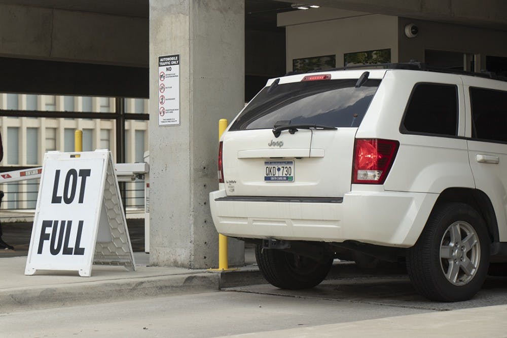Cars in queue to find parking at Bull Street Garage on the University of South Carolina Campus, 11 September 2019.