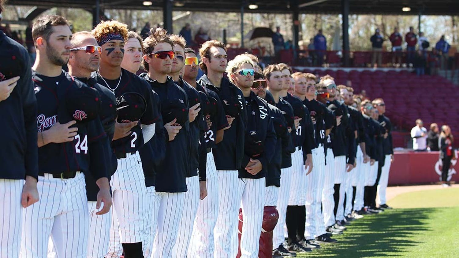 FILE — The South Carolina baseball team stands during the Star-Spangled Banner before the game against Texas at Founders Park on March 13, 2022.