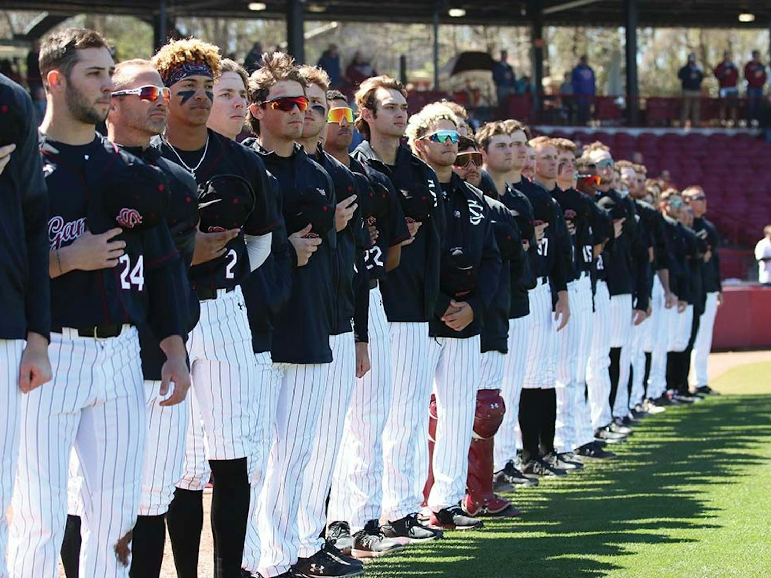 FILE — The South Carolina baseball team stands during the Star-Spangled Banner before the game against Texas at Founders Park on March 13, 2022. 