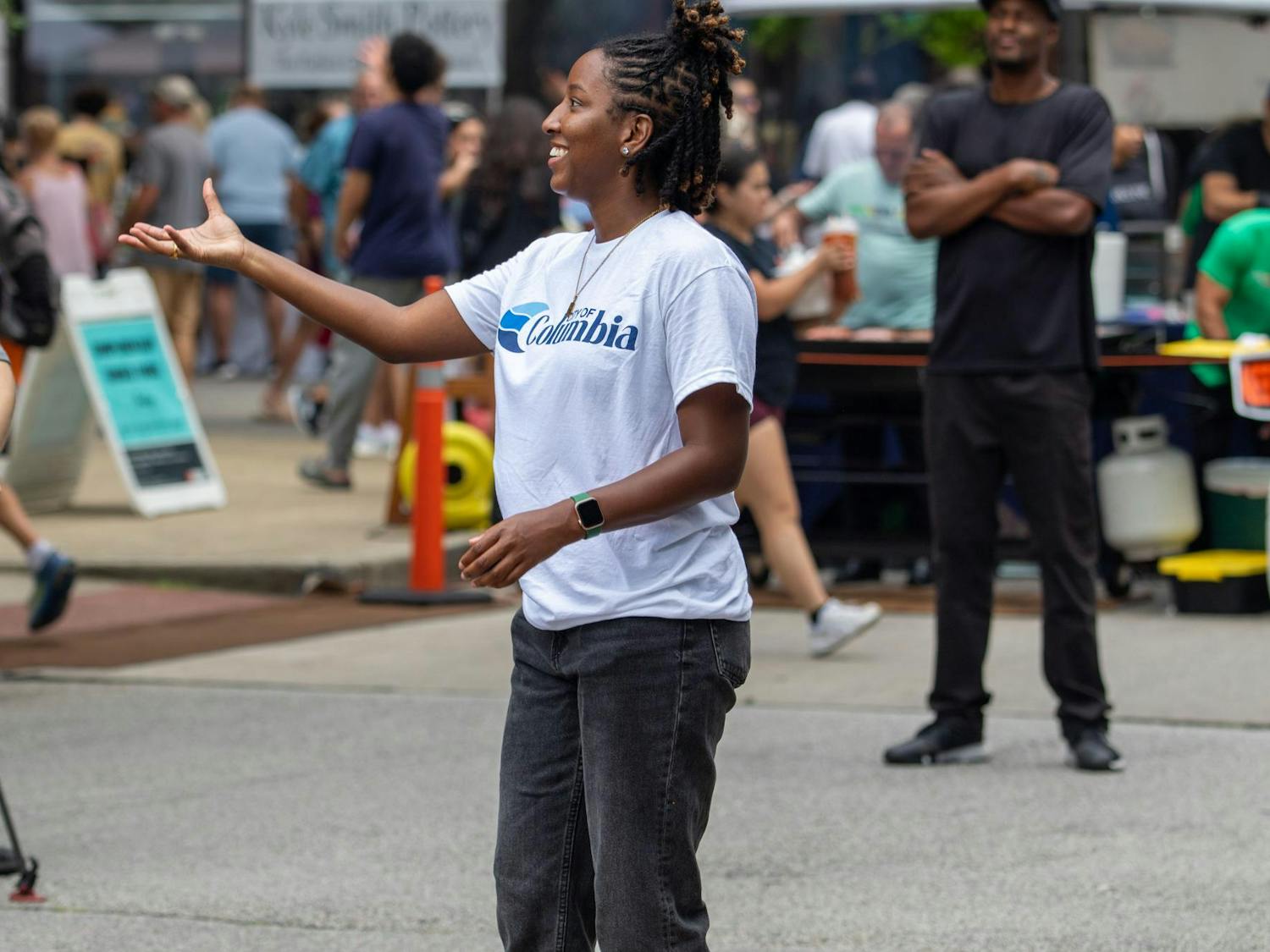 A participant catches the ball being thrown to hit the target for the dunk booth at Soda City Market on July 27, 2024. Participants and others at Soda City Market watched as Columbia figures were sent underwater in the booth.