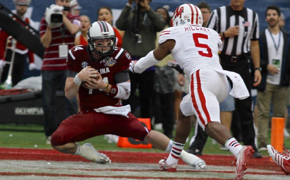 	Senior quarterback Connor Shaw brings down a pass from junior wide receiver Bruce Ellington in the 2014 Capital One Bowl.