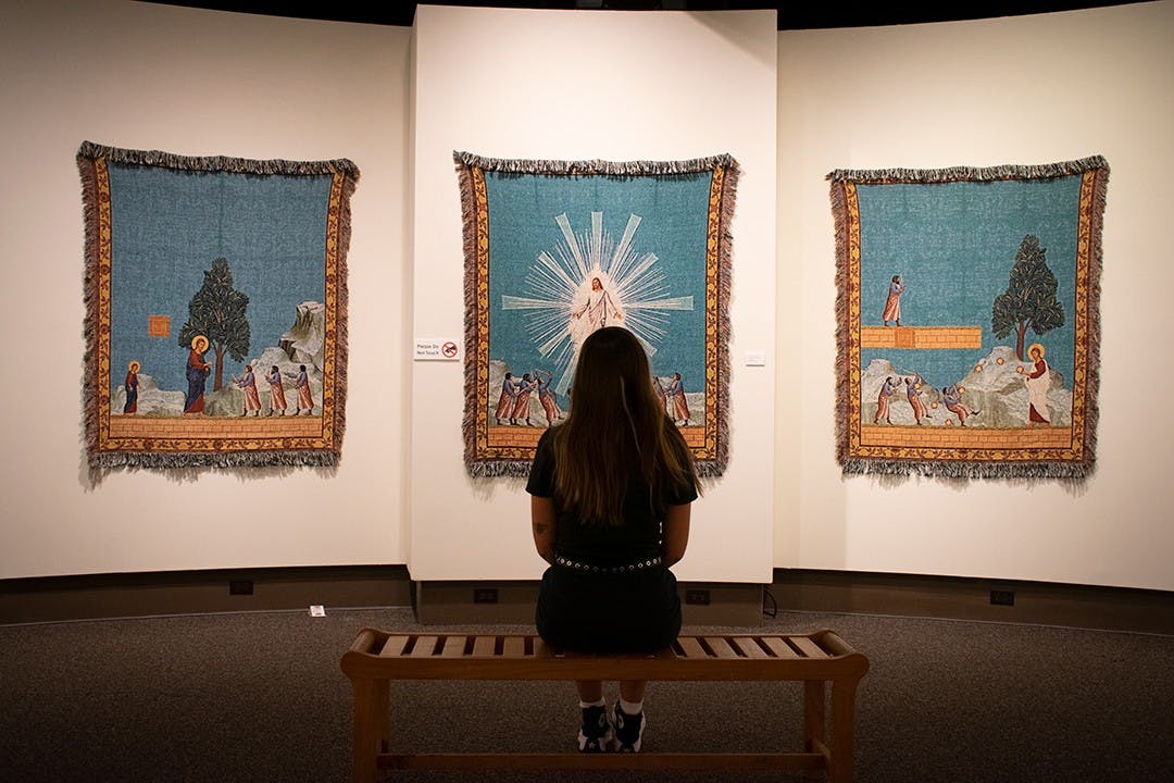 A museum-goer observes “Hyphen-ated," an art exhibit in the McKissick Museum. The works of Dan Hernandez and Arturo Rodriguez incorporate ideas of race religion and pop-culture.