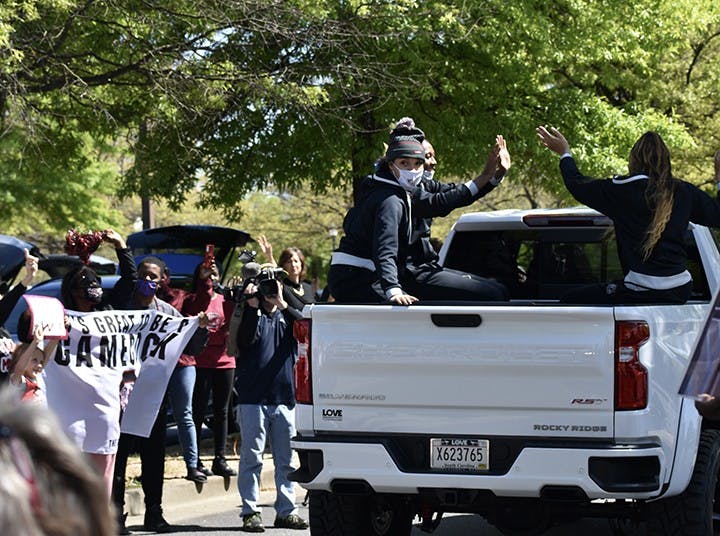 Fans wave, give a “thumbs up,” cheer and wave rally towels to praise the USC women’s basketball team.