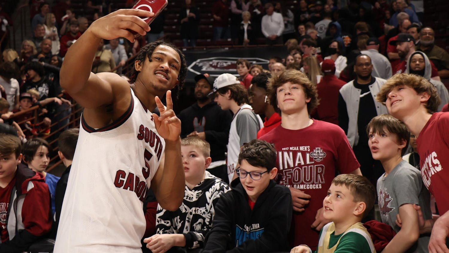 FILE - Junior guard Meechie Johnson takes pictures with fans after South Carolina's win against Vanderbilt on Feb. 10, 2024. The Gamecock men's basketball team defeated the Commodores 75-60 at Colonial Life Arena.