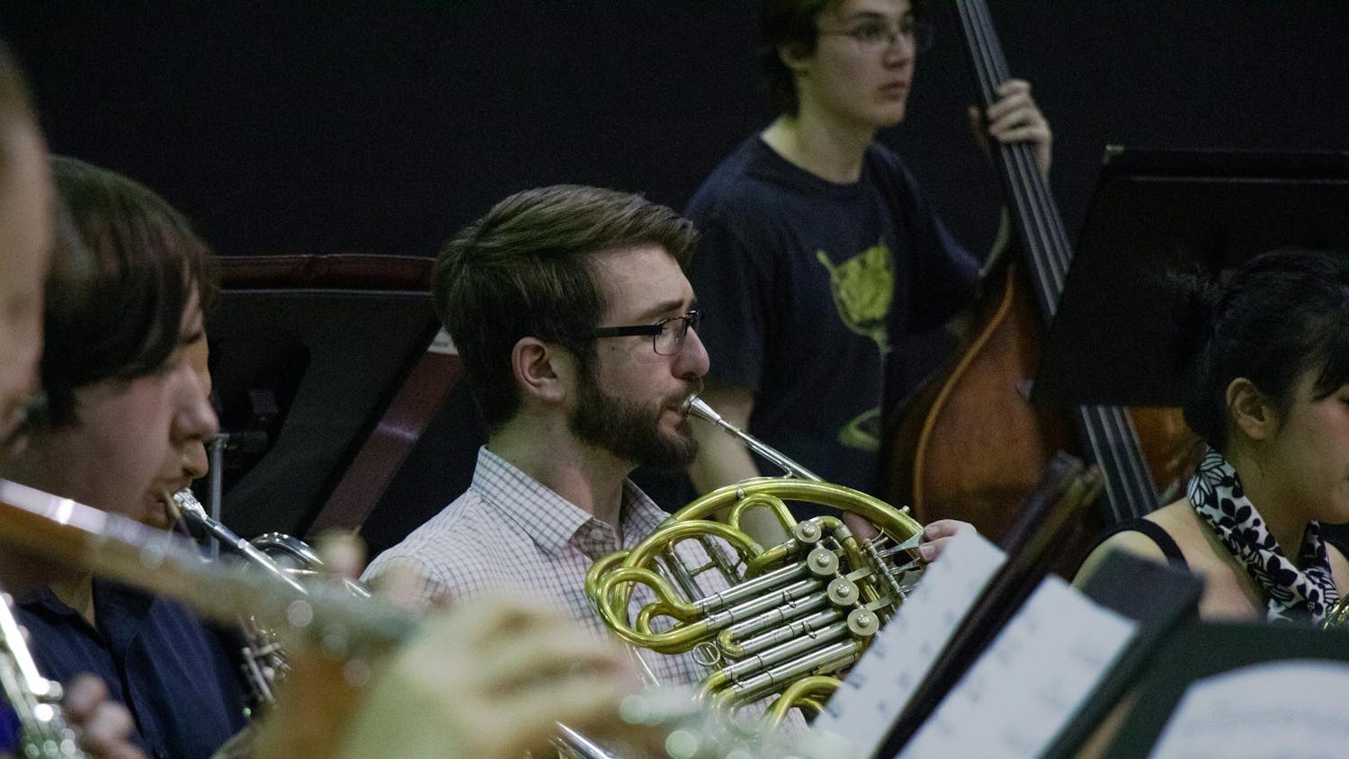 A University of South Carolina student plays the French horn during a wind ensemble rehearsal on March 21, 2024. The  Wind Ensemble is open to students of all majors by audition.