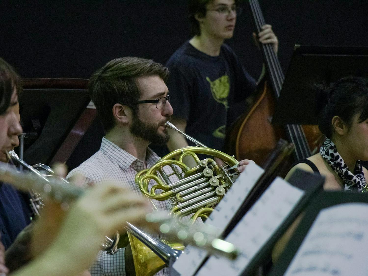 A University of South Carolina student plays the French horn during a wind ensemble rehearsal on March 21, 2024. The USC Wind Ensemble is open to students of all majors by audition.