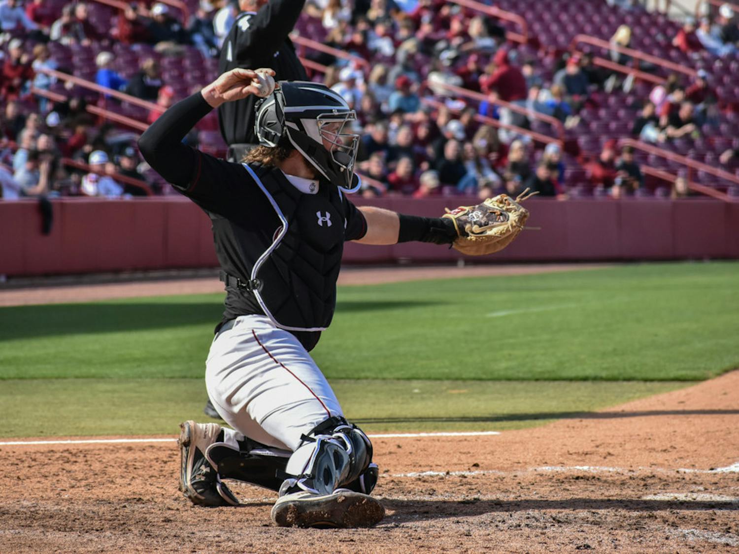 Sophomore catcher Talmadge LeCroy catches the ball in-between innings during the game on February 19, 2023. The South Carolina baseball team won against UMass Lowell 12-1.