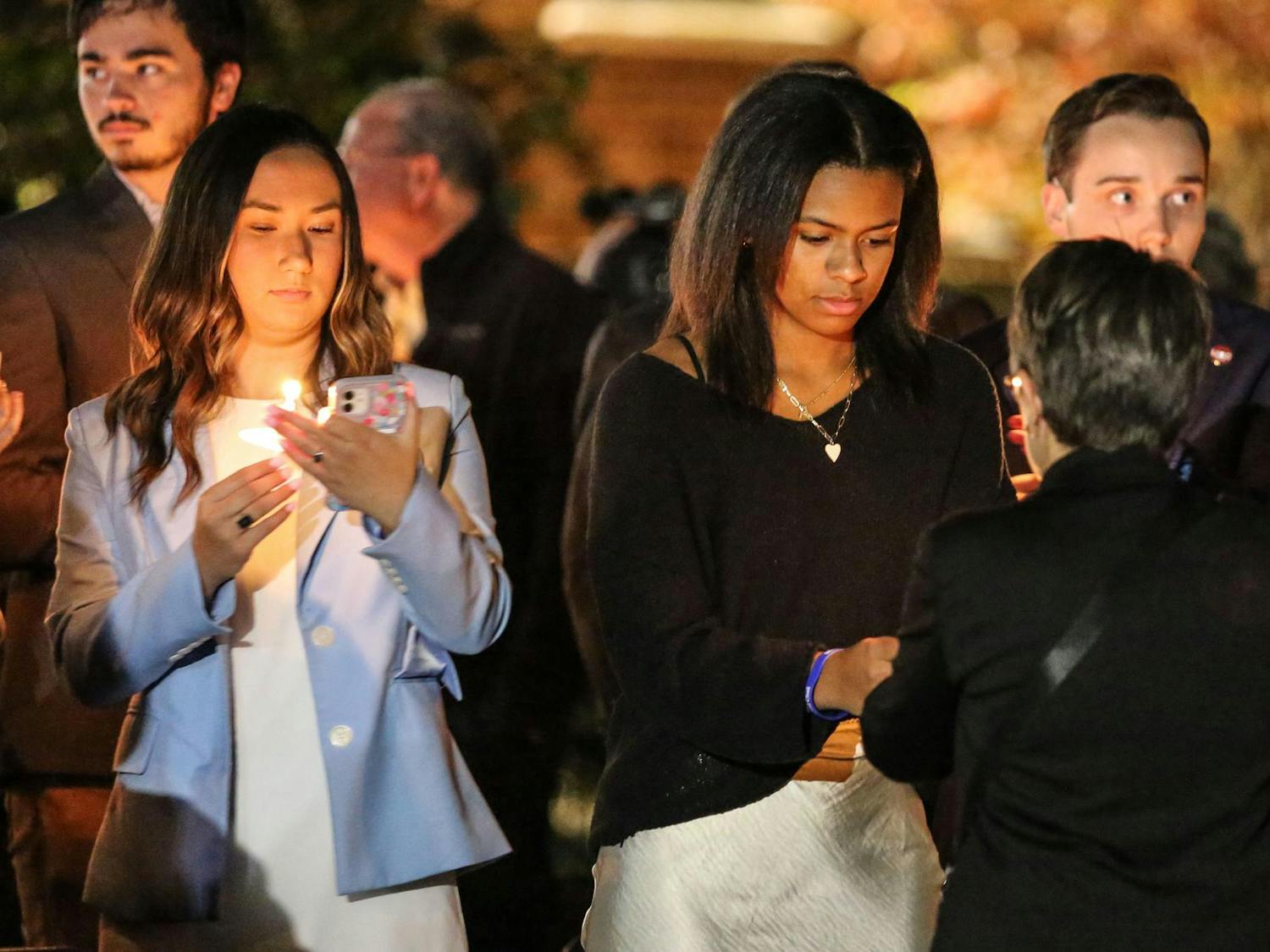 Fourth-year public relations student and Student Body President Emmie Thompson and third-year marketing and finance student and Student Body Vice President Abrianna Reaves light their candles prior to a Jewish community vigil in the garden of the Anne Frank Center at the University of South Carolina on Oct. 17, 2023. The vigil was hosted by Gamecocks for Israel, Hillel at UofSC, Alpha Epsilon Pi, Chabad on Campus and the University of South Carolina.