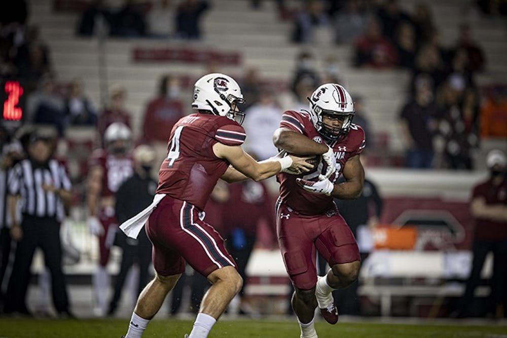 Freshman quarterback Luke Doty hands the ball off to sophomore running back Kevin Harris in South Carolina's loss to Georgia Saturday. The Gamecocks fell to a 2-7 record after the loss.