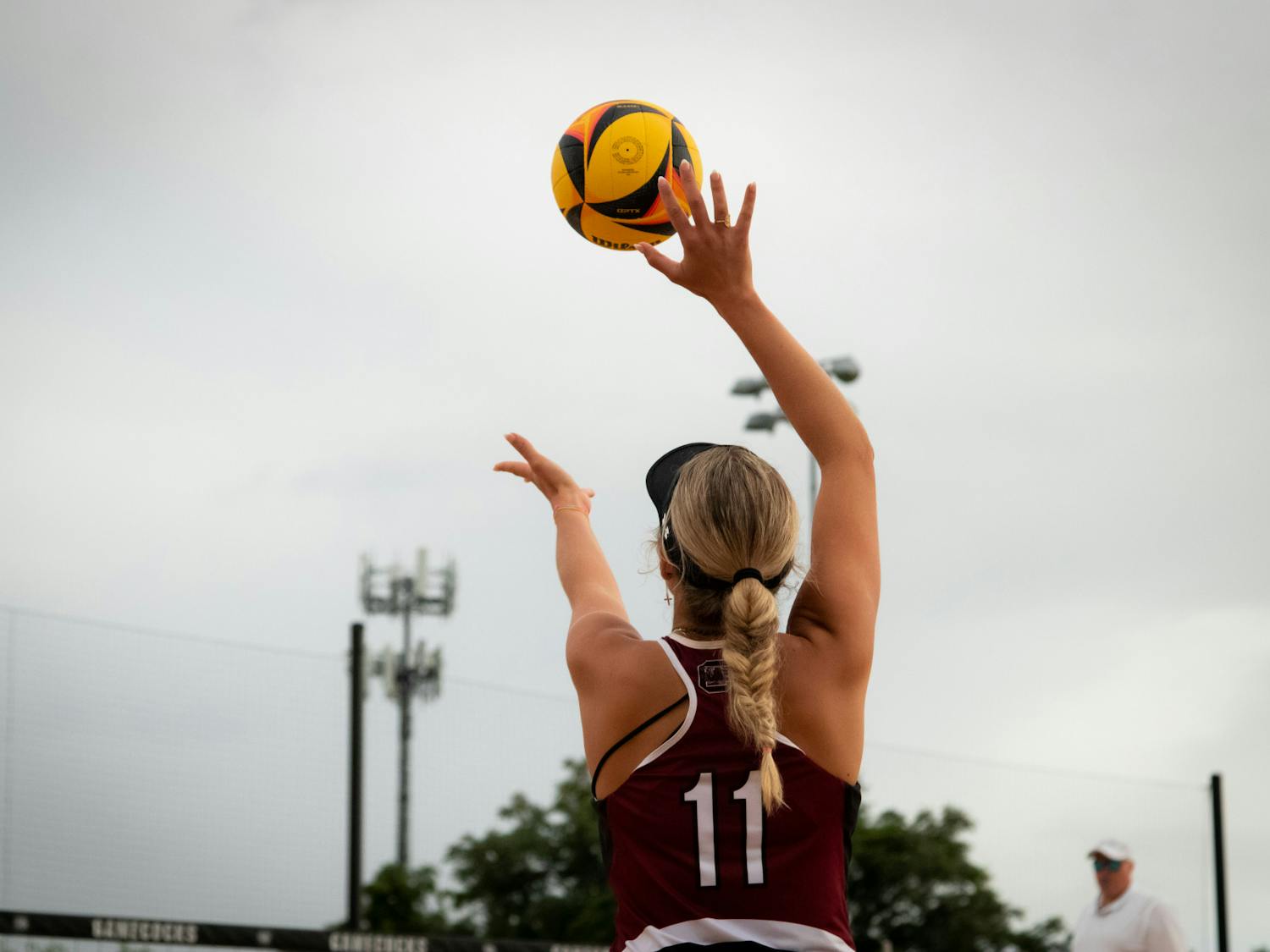 Junior Lizzie Thompson sets the ball to serve to Coast Carolina on April 14, 2023. Thompson and senior Peyton Gray won their match in two sets, contributing to an overall 3-2 win for the Gamecocks. 