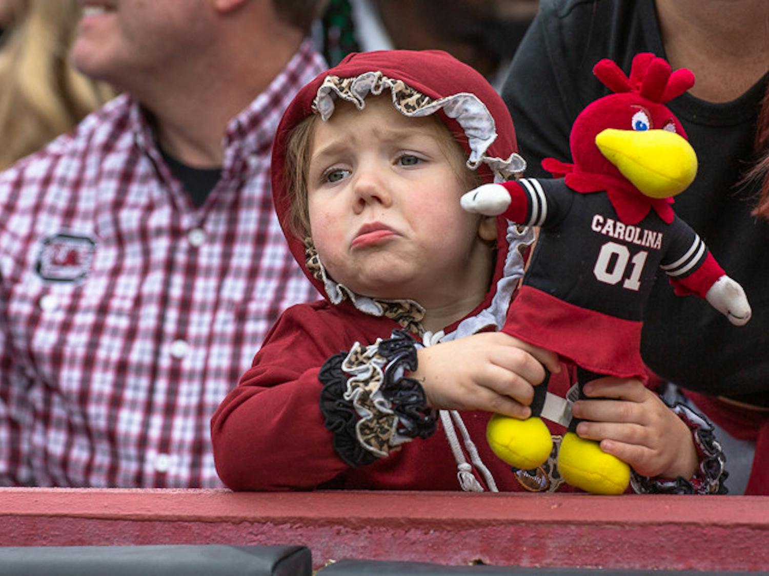 A girl dressed in her Halloween costume, holding a Cocky doll pouts after a play during the South Carolina and Missouri game on Oct. 29, 2022. The game fell on the weekend of Halloween, prompting many students and fans to dawn their costumes for the event.