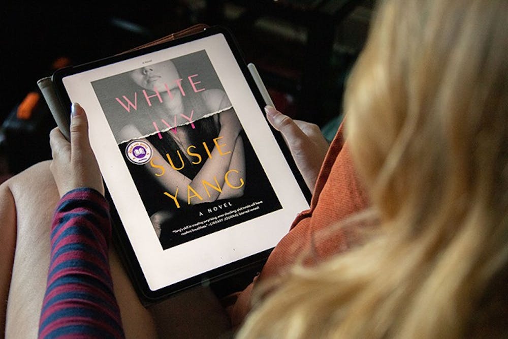 <p>&nbsp;&nbsp;A woman sits down on a chair to read the e-book version of Susie Yang's novel "White Ivy.”&nbsp;</p>