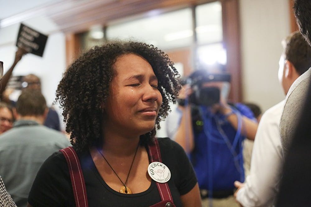 <p>Second-year psychology student Deanna Smith cries in reaction to the announcement of the selection of Gen. Robert Caslen as the next president of USC.&nbsp;</p>