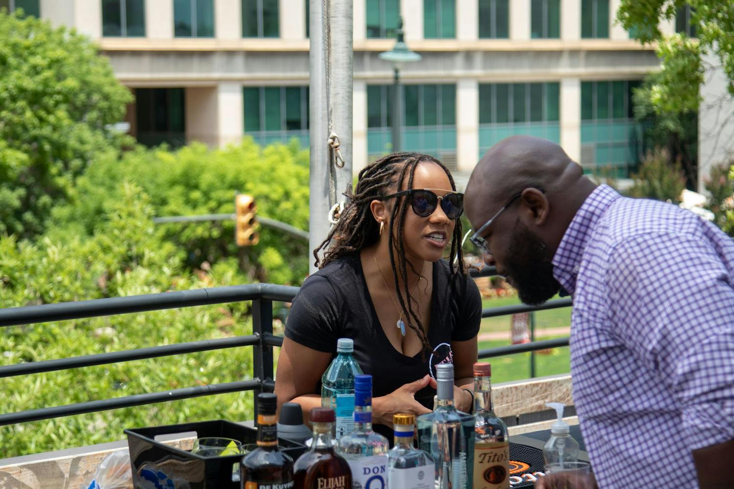Crystal Stevens, a bartender at ITM Bartending, talks to a patron before the Capital City Cocktail Competition on June 9, 2024. Attendees enjoyed curated craft cocktails at the Palmetto Patio during the competition.