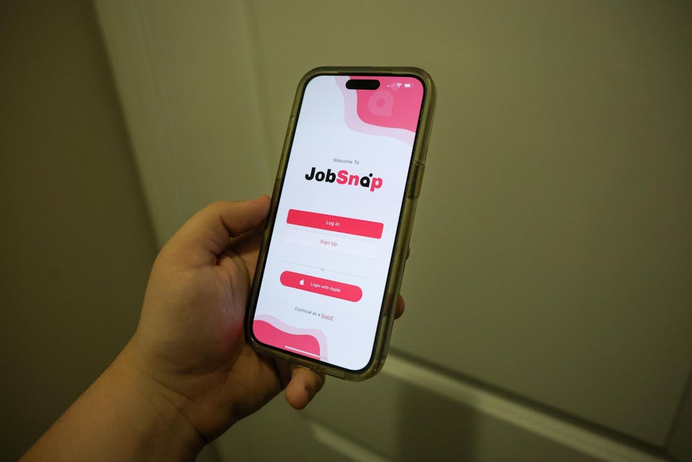<p>A phone displays the login page for JobSnap. The app was developed by USC alum James Albis.</p>