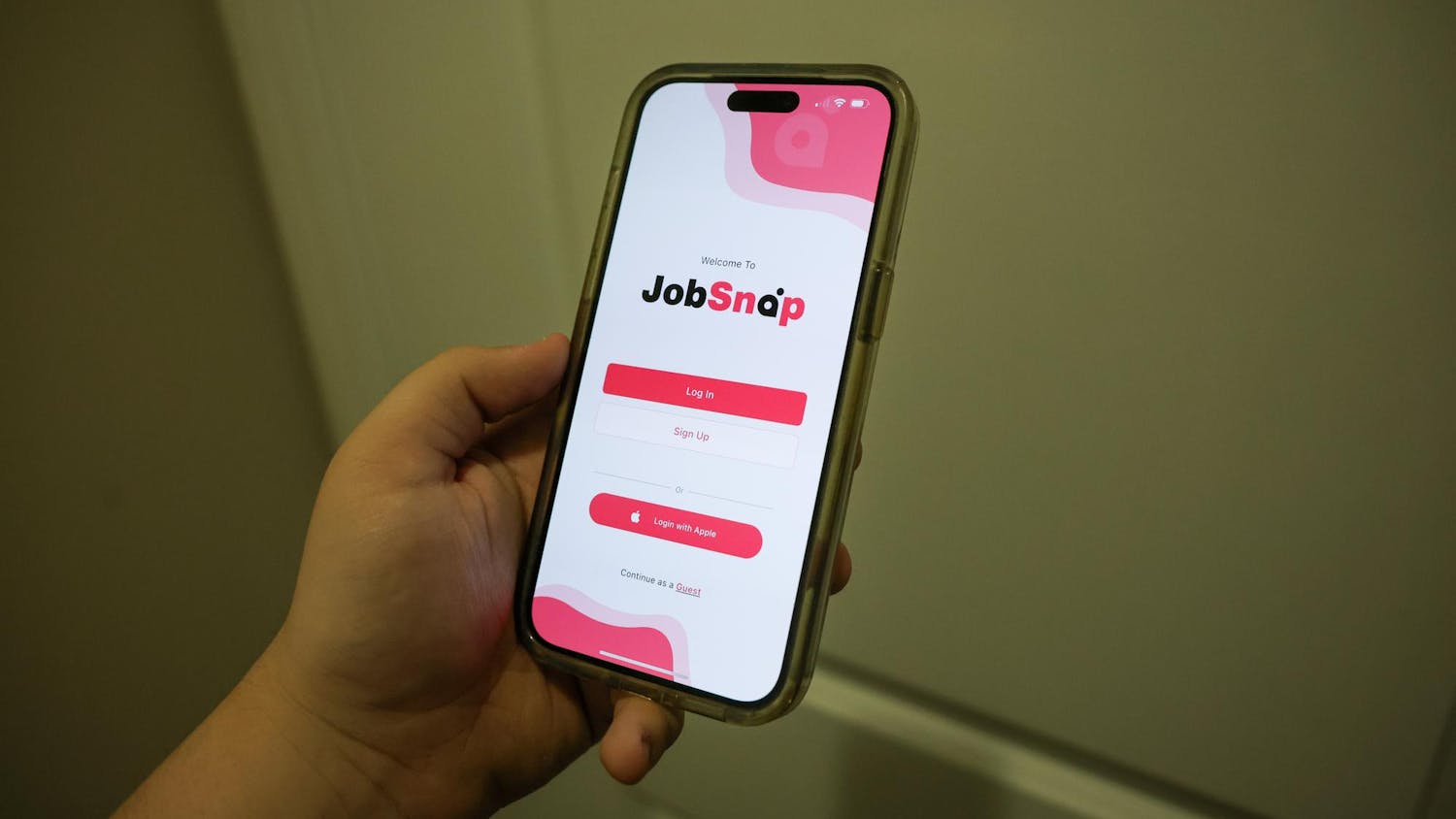 A phone displays the login page for JobSnap. The app was developed by USC alum James Albis.