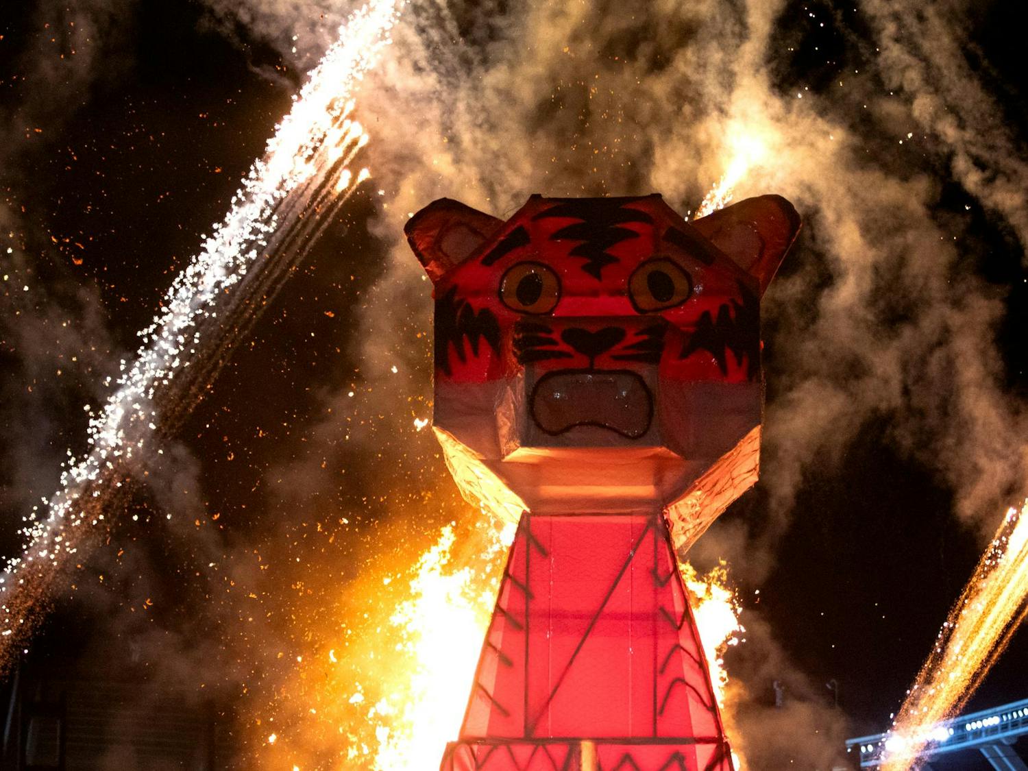 Fireworks go off as the wooden tiger — constructed by the USC chapter of the American Society of Mechanical Engineers and the Society of Hispanic Professional Engineers — is set aflame. The tiger has been built to be more than 30 feet tall for several years.