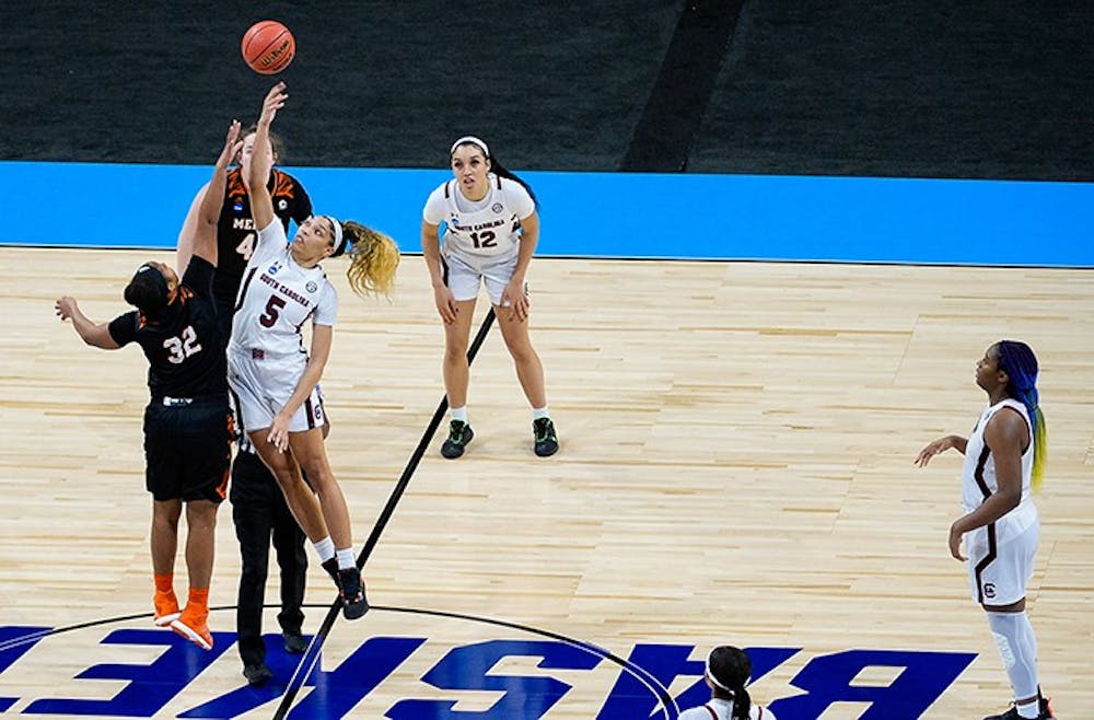 <p>Junior forward Victaria Saxton jumps next to a Mercer player and tries to tip the ball to her fellow teammates. South Carolina beat Mercer in the NCAA Tournament 79-53.&nbsp;</p>