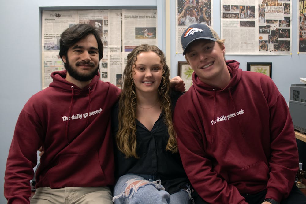 <p>The Daily Gamecock's managing staff poses for a photo in the newsroom on Nov. 20, 2022. Editor-in-Chief Kailey Cota and managing editors Tyler Fedor (left) and Michael Sauls (right) have each worked with The Daily Gamecock for seven semesters and will step down on Dec. 12, 2022.</p>