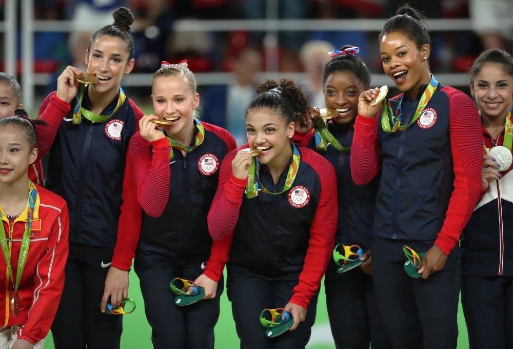 From left, Alexandra Raisman, Madison Kocian, Lauren Hernandez, Simone Biles and Gabby Douglas celebrate on the medal stand on August 9, 2016, at the Rio Olympic Games in Rio De Janeiro, Brazil. The U.S. women's squad captured the gold medal in the team competition. (Brian Peterson/Minneapolis Star Tribune/TNS)