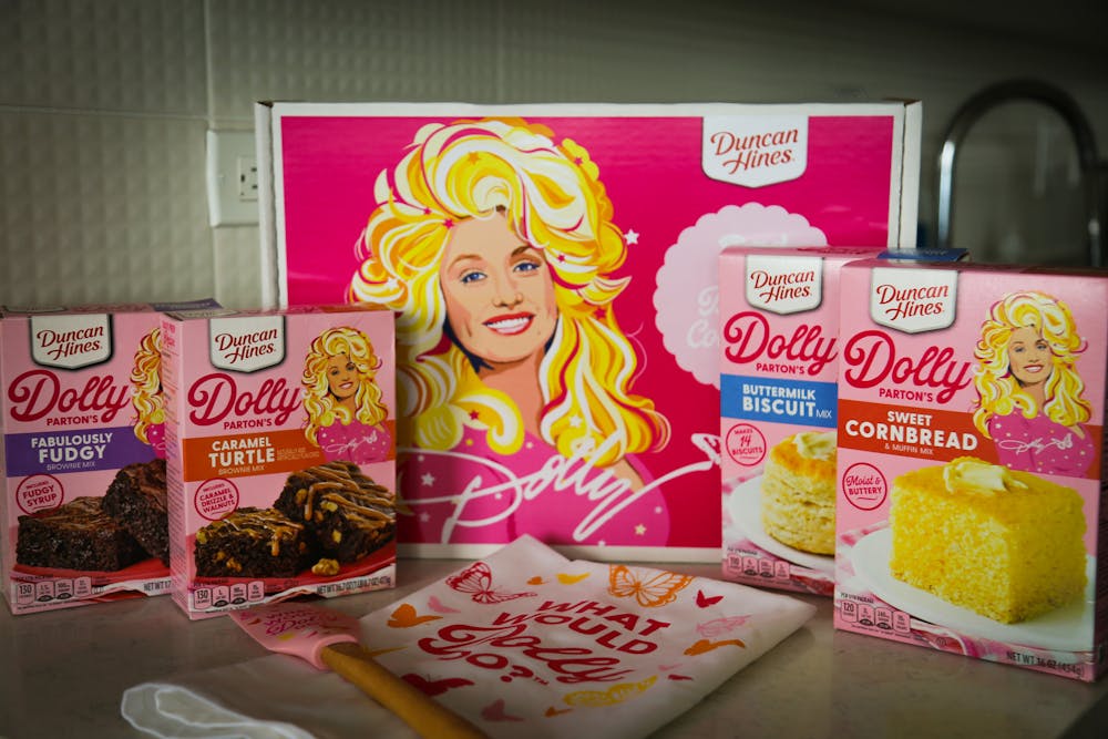 <p>A photo illustration of Duncan Hines' Dolly Parton Baking Collection on Feb. 22, 2023. The kit was released early this month and includes two types of brownie mixes, a cornbread mix, a biscuit mix, a matching towel and spatula and collectible recipe cards.</p>