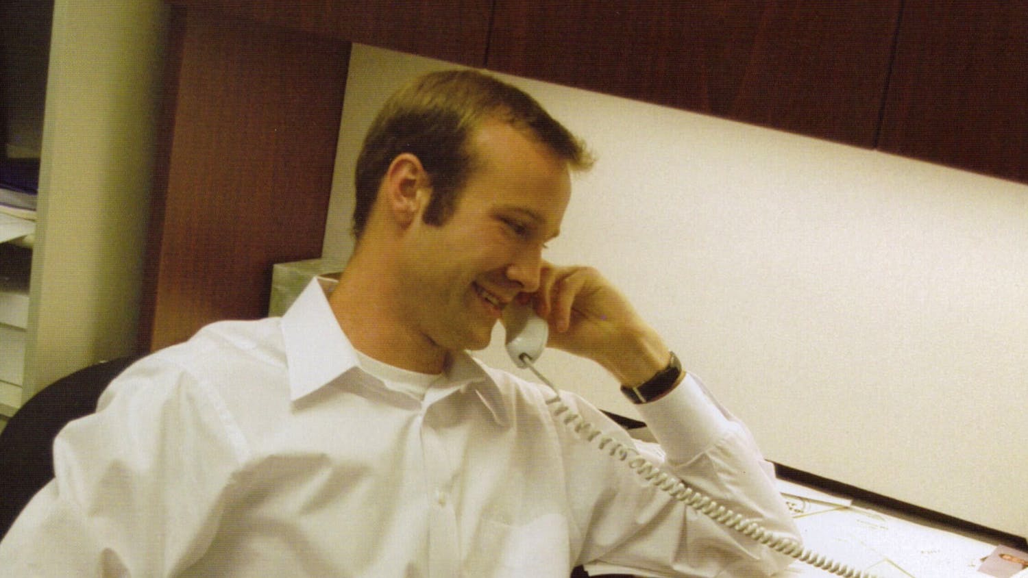 Zachery Scott sits at his desk answering a phone call during his time in student government. Scott, the first openly LGBTQIA+ student body president, was elected in 2004.