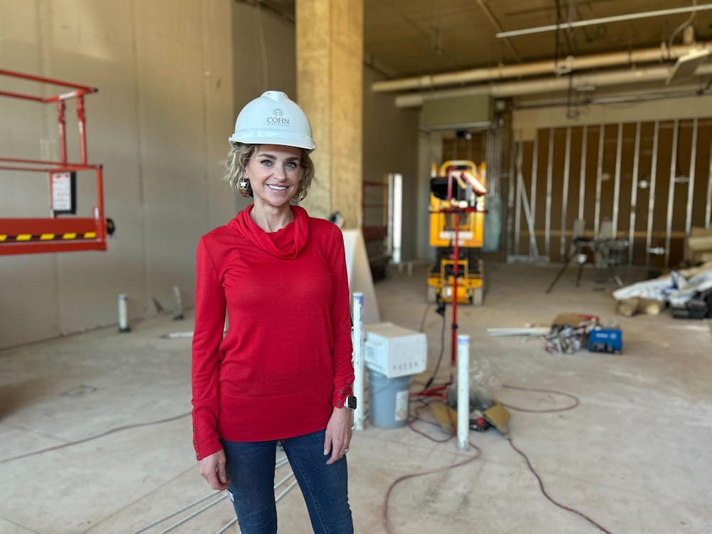<p>Owner Ashley Lamb stands inside the construction of the retail space for the new Pvolve Studios in the Bull Street District on Feb. 14, 2023. Located in the new Bennett at Bull Street Apartments, Pvolve Studios opened in May to offer many different workouts and training programs.</p>