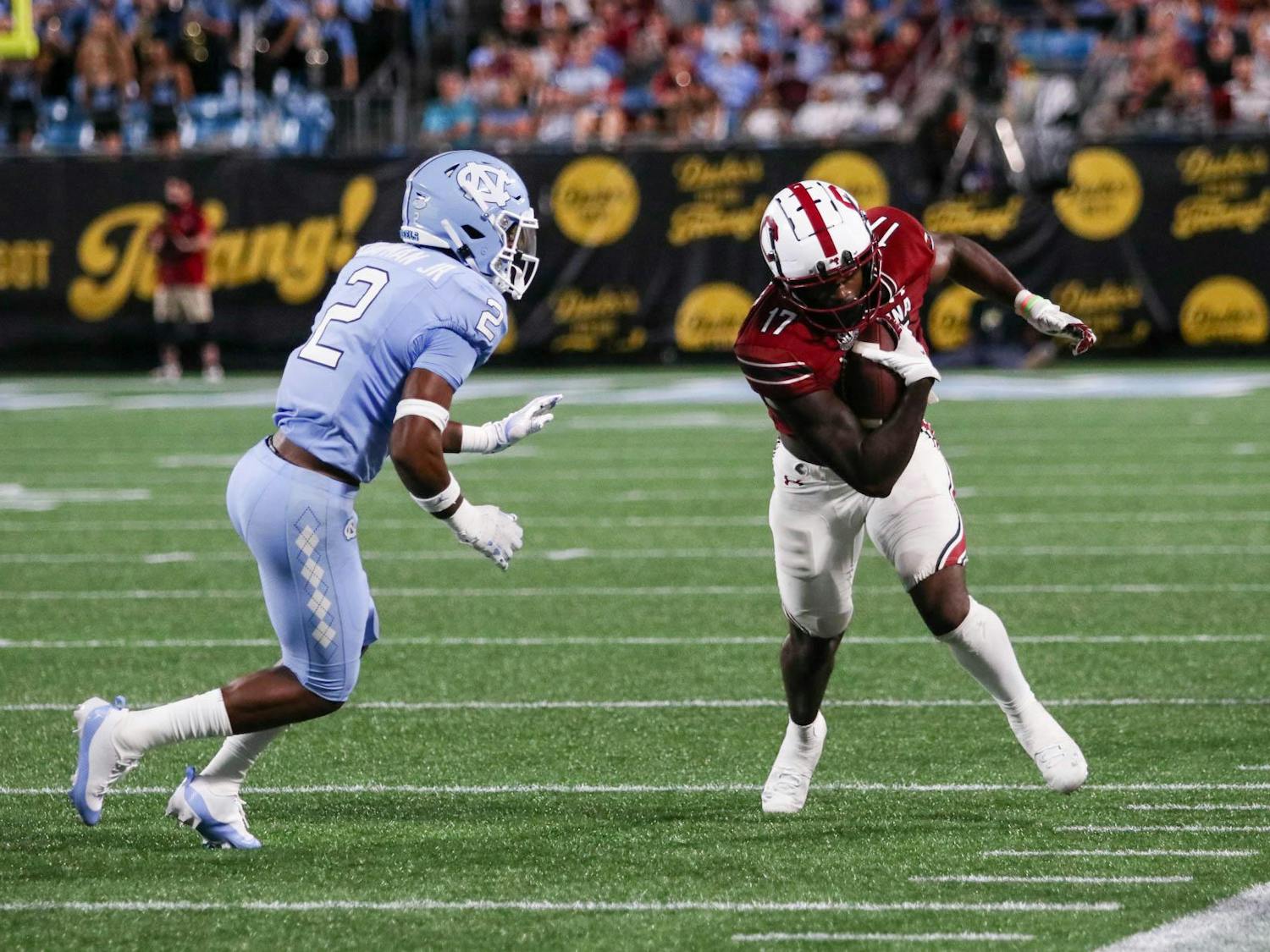 Fifth-year wide receiver Xavier Legette dodges a player from the University of North Carolina as he runs. Legette received nine balls for a combined 178 yards during the game.