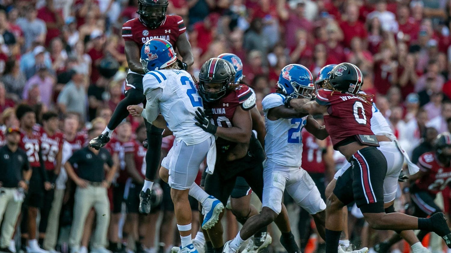 FILE — Junior defensive back DQ Smith jumps to try and block the pass while redshirt junior defensive tackle T.J. Sanders goes for the tackle during South Carolina's game against Ole Miss on Oct. 5, 2024, at Williams-Brice Stadium. The Gamecocks are 3-3 overall following a week six loss to Alabama.