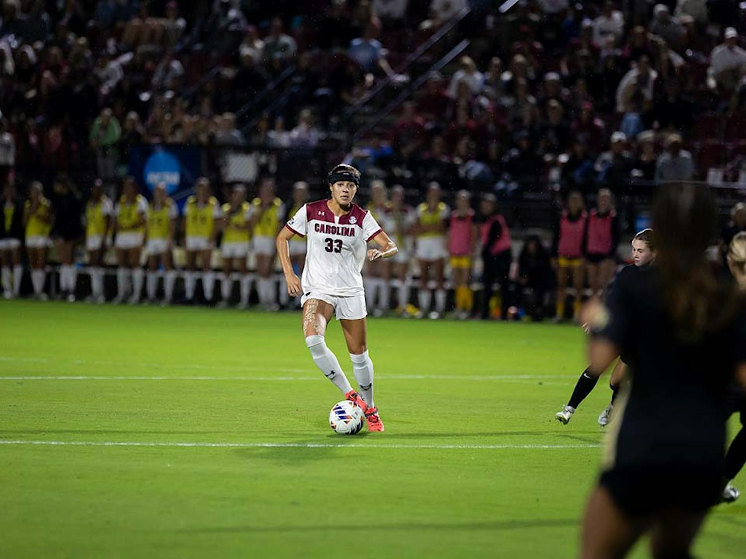 Fifth-year defender Jylissa Harris looks for an open teammate to pass the ball to as Wake Forest defenders close in. Harris contributed to the score, making one goal against Wake Forest at Stone Stadium on Nov. 12, 2022.