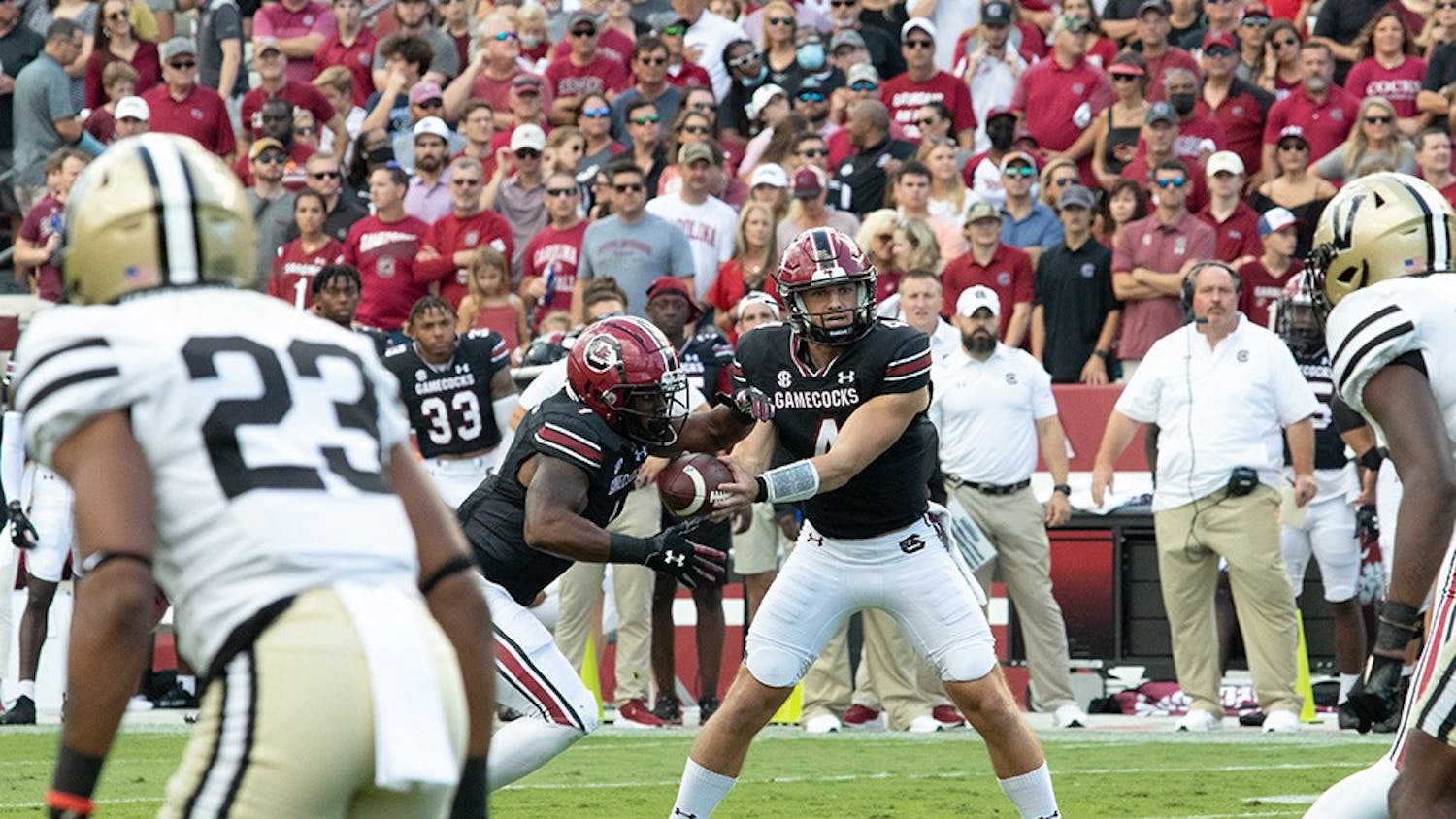 FILE—Junior quarterback Luke Doty hands the ball off to redshirt sophomore running back MarShawn Lloyd for a gain of a couple yards against Vanderbilt on Oct. 16, 2021. The Gamecocks won 21-20.&nbsp;