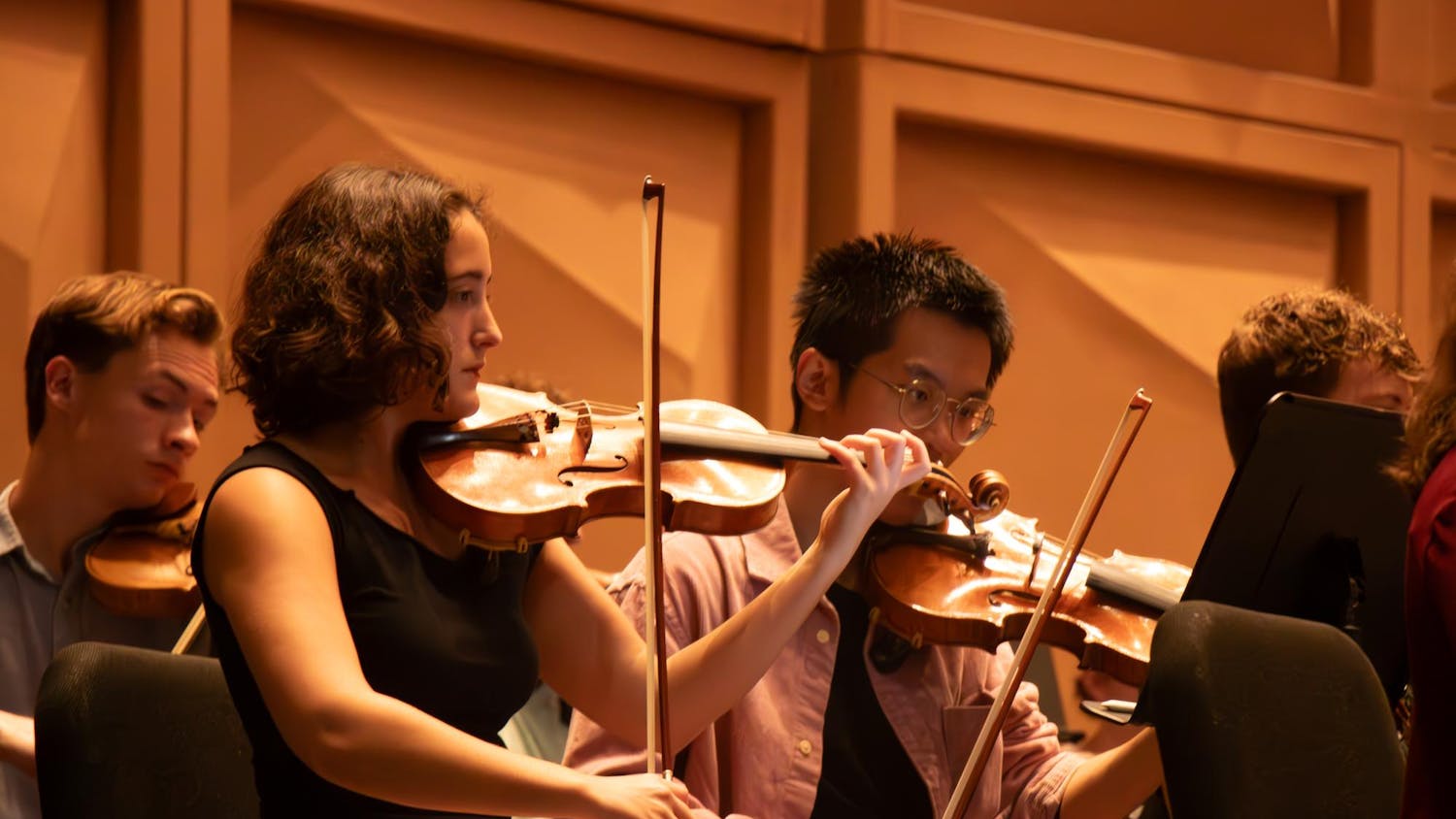 Second-year music performance major Margie Moore reads her sheet music while sitting in the violin section of The Firebird and Phoenix at the Koger Center on Sept. 23, 2024.