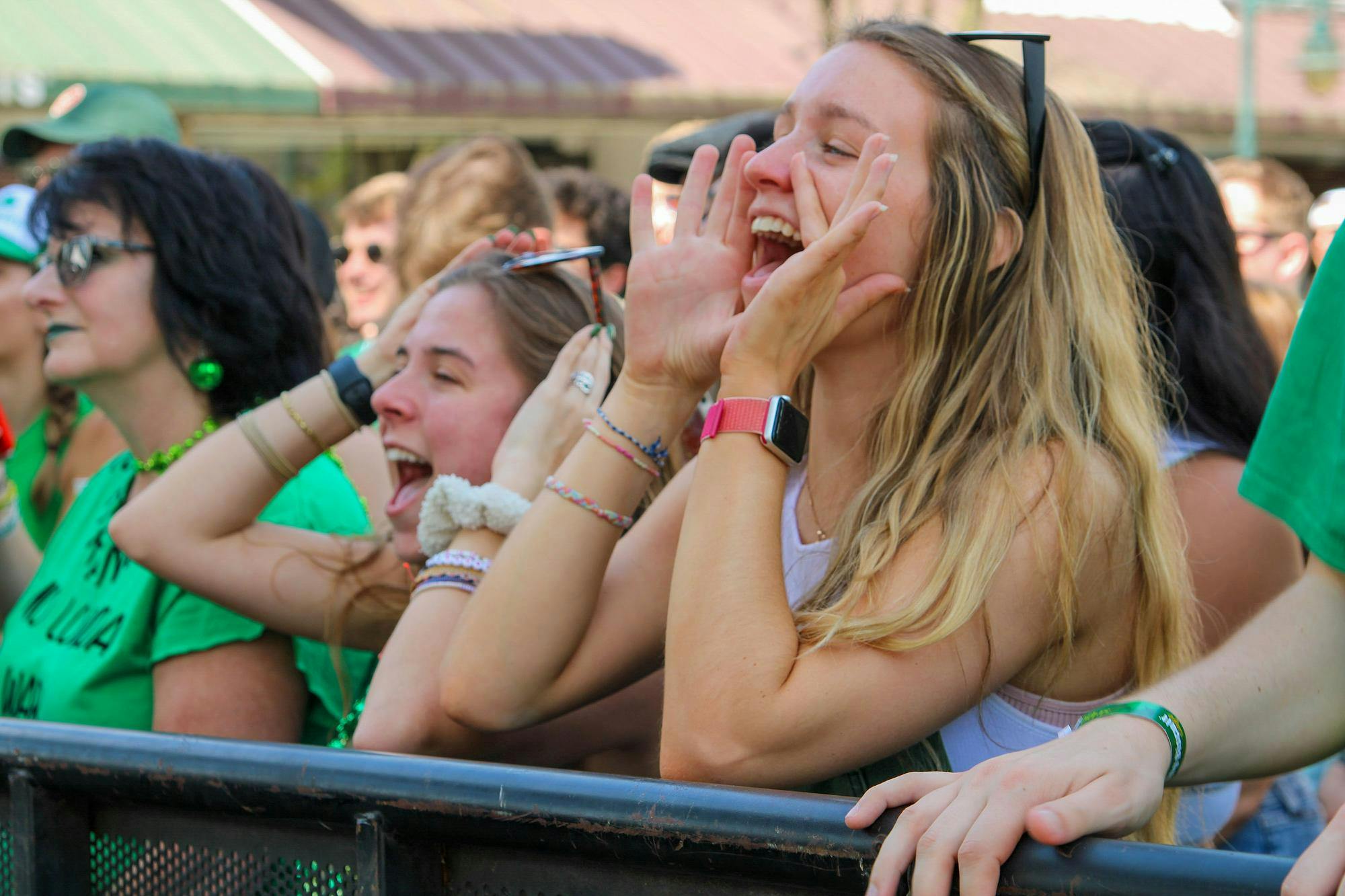 Third-year student Ramsey McIntyre cheers as the band Happy Landing performs during St. Pat's in Five Points in Columbia, South Carolina on March 16, 2024. The band was one of six acts to perform on the Blossom Stage.