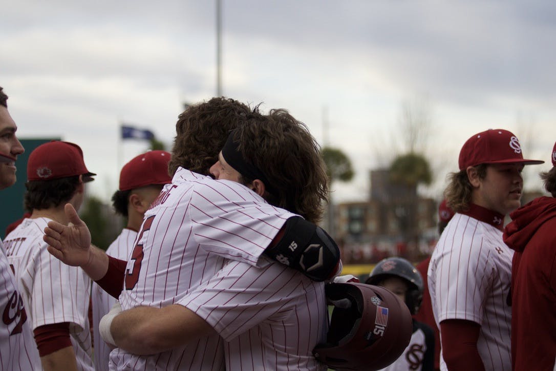 Sophomore outfielder Carson Hornung and sophomore catcher Cole Messina share a celebratory hug during the Gamecocks matchup versus UMass Lowell. South Carolina defeated the Riverhawks 20-3 on opening day on Feb. 17, 2023.  