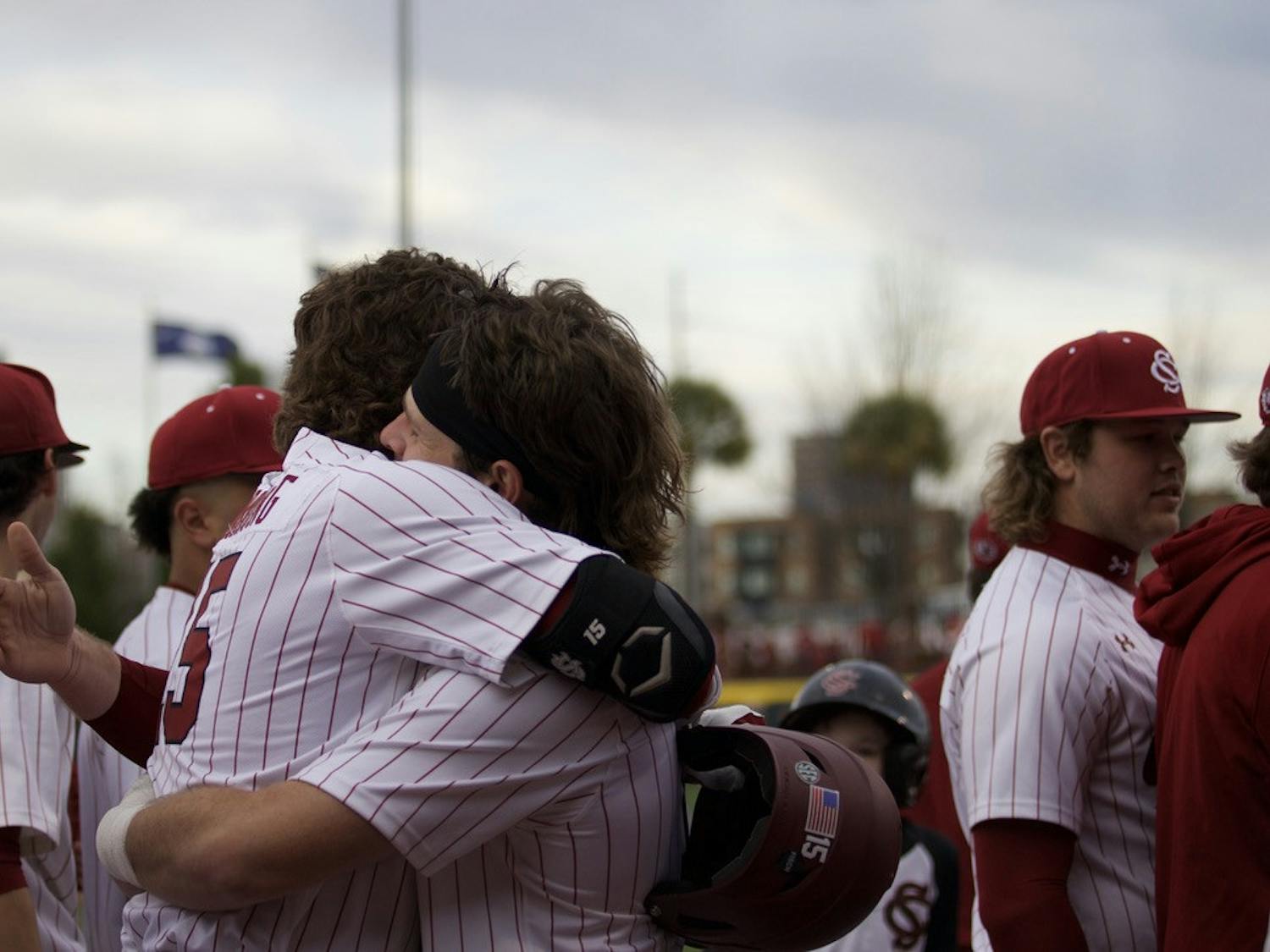 Sophomore outfielder Carson Hornung and sophomore catcher Cole Messina share a celebratory hug during the Gamecocks matchup versus UMass Lowell. South Carolina defeated the Riverhawks 20-3 on opening day on Feb. 17, 2023.  