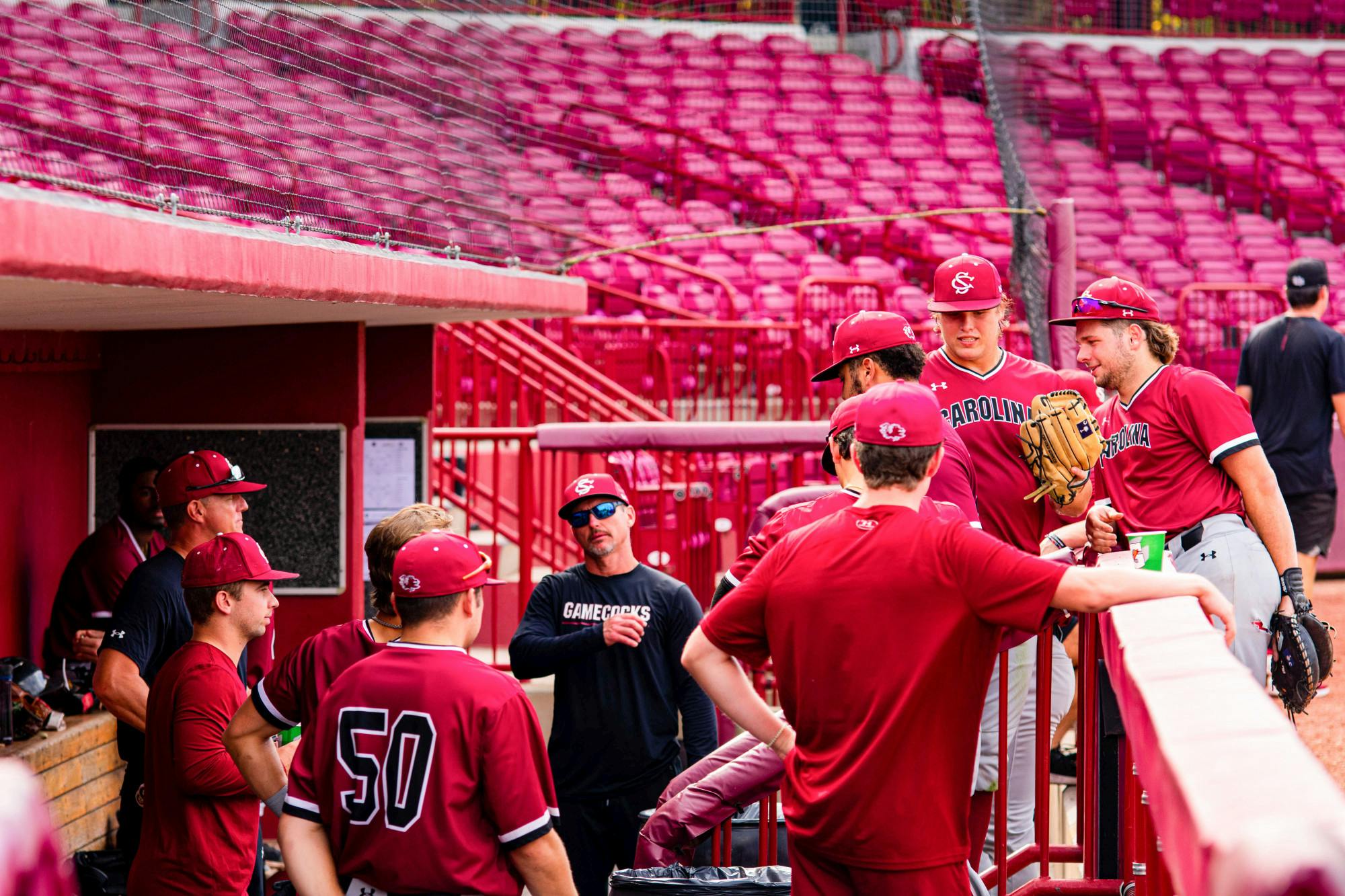 The Garnet team waits to take the field in its dugout with assistant head coach Monte Lee during their Garnet and Black scrimmage on Nov. 2, 2022. This year's team finished off its past season with a record of 27-28 overall.&nbsp;