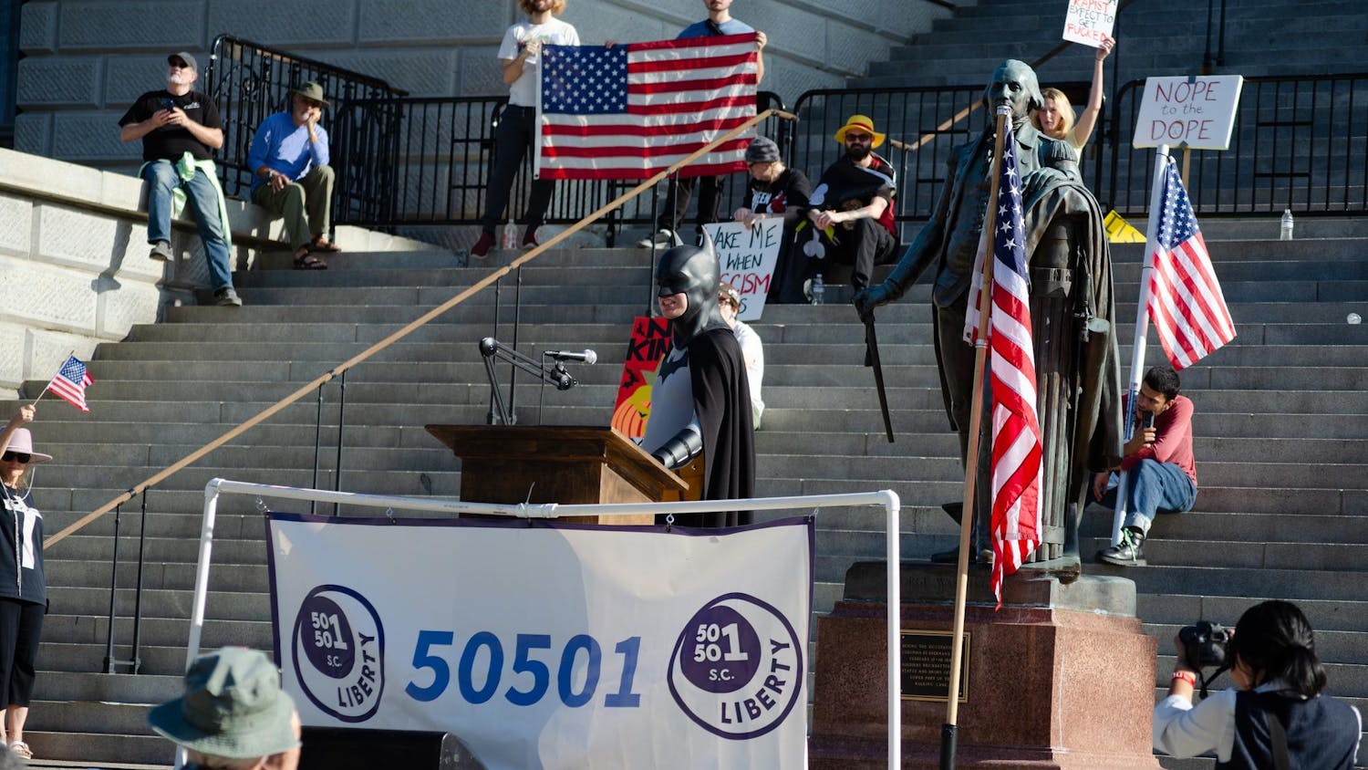 A protester dressed as Batman speaks to the crowd at a "No Kings" protest in Columbia, South Carolina on Oct. 18, 2025. The "Downtown Batman" is a self-proclaimed “real-life superhero” who gives food, water and clothing to the homeless in Greenville, South Carolina.