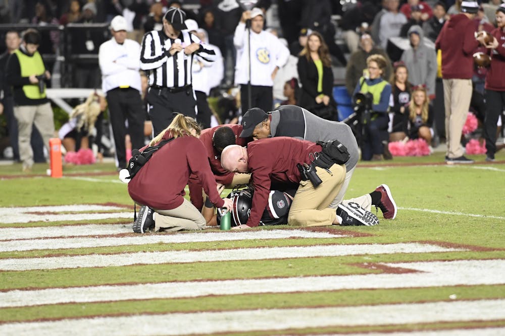 <p>Head football athletic trainer Clint Haggard and other athletic training staff tend to an injured player at a regular season Gamecock football game. Haggard and his staff practice emergency responses in a number of locations five to six times a year in order to be prepared for any situation.&nbsp;</p>