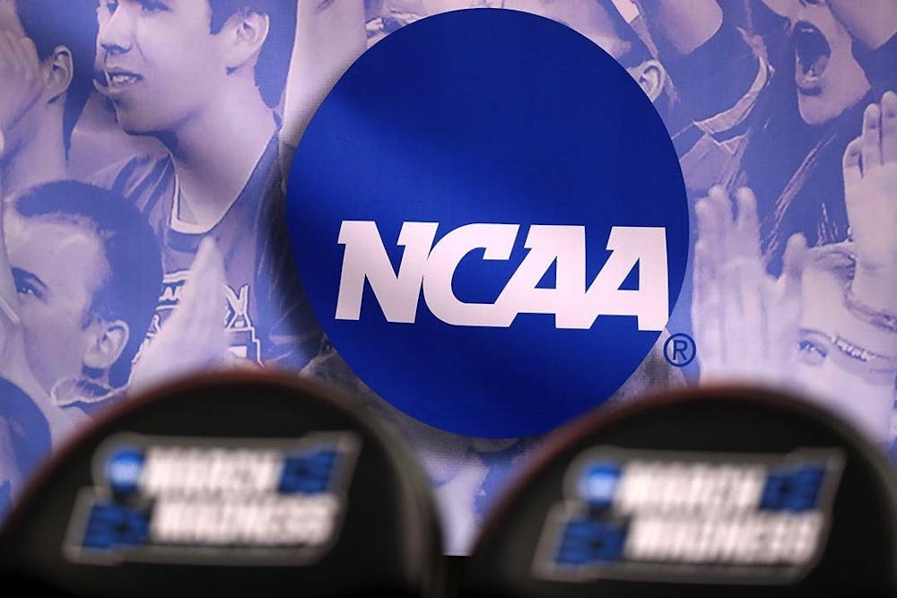 <p>The NCAA logo during the NCAA Men’s Basketball Tournament in 2017. The NCAA is changing its rules to allow players within the organization to earn money from their name, image and likeness (NIL).</p>