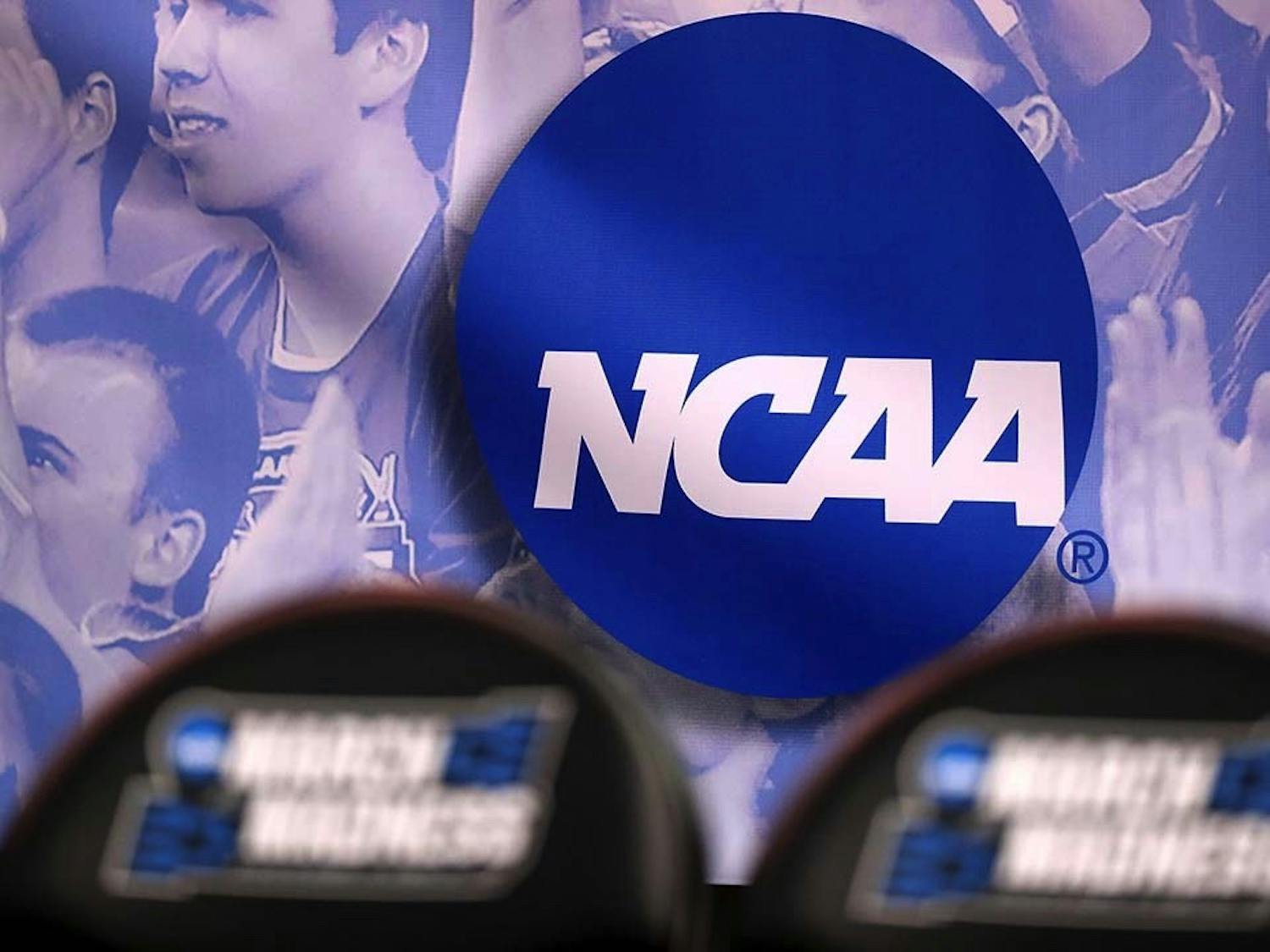 The NCAA logo during the NCAA Men’s Basketball Tournament in 2017. The NCAA is changing its rules to allow players within the organization to earn money from their name, image and likeness (NIL).