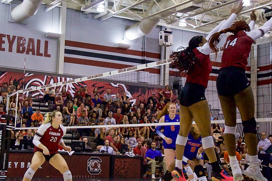 (No. 16) Oby Anadi and (No. 14) Kiune Fletcher block the ball during the second set in the Gamecocks matchup versus the Gators on Sept. 24, 2022