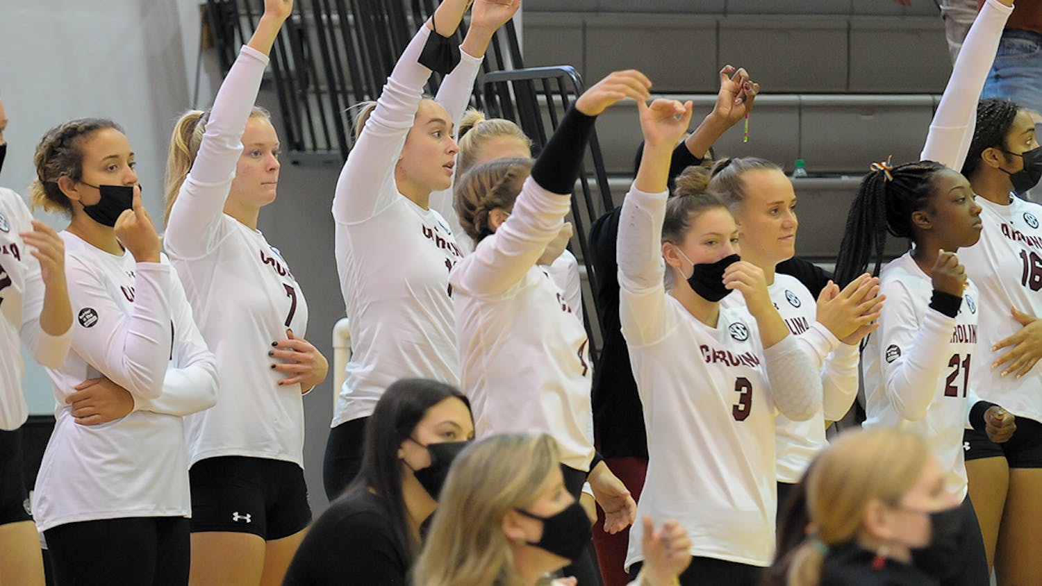 Members of the Women’s Volleyball team hold up their pinkies to signify one more point needed to win the set against Alabama. 