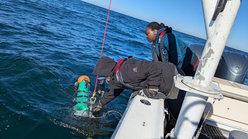 <p>Lydia Sims and Amadi Afua Sefah-Twerefour are deploying one of the three moorings with their hydrophone to listen for North Atlantic right whales during the calving season in Savannah, Georgia.</p>