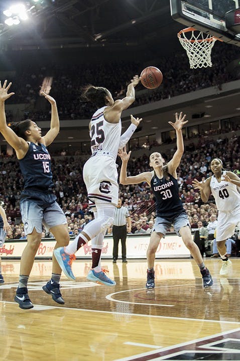 Tiffany Mitchell passes to Alaina Coates in hopes she can make the shot. Communication on the court was clear as players responded to each other's words and signals. 