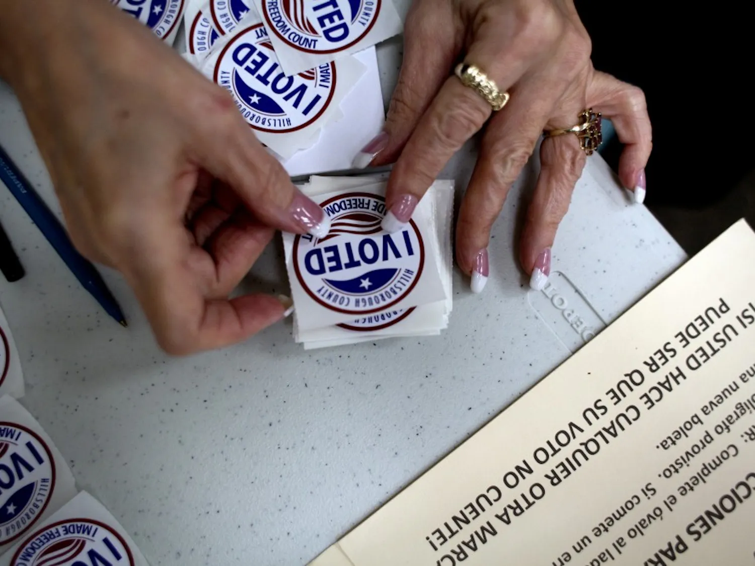 A poll worker gets "I Voted" stickers ready to hand to voters as they finished up at the ballot booths at Jan Kaminis Platt Regional Library in South Tampa, Fla., on November 6, 2012. (Carolina Hidalgo/Tampa Bay Times/TNS)