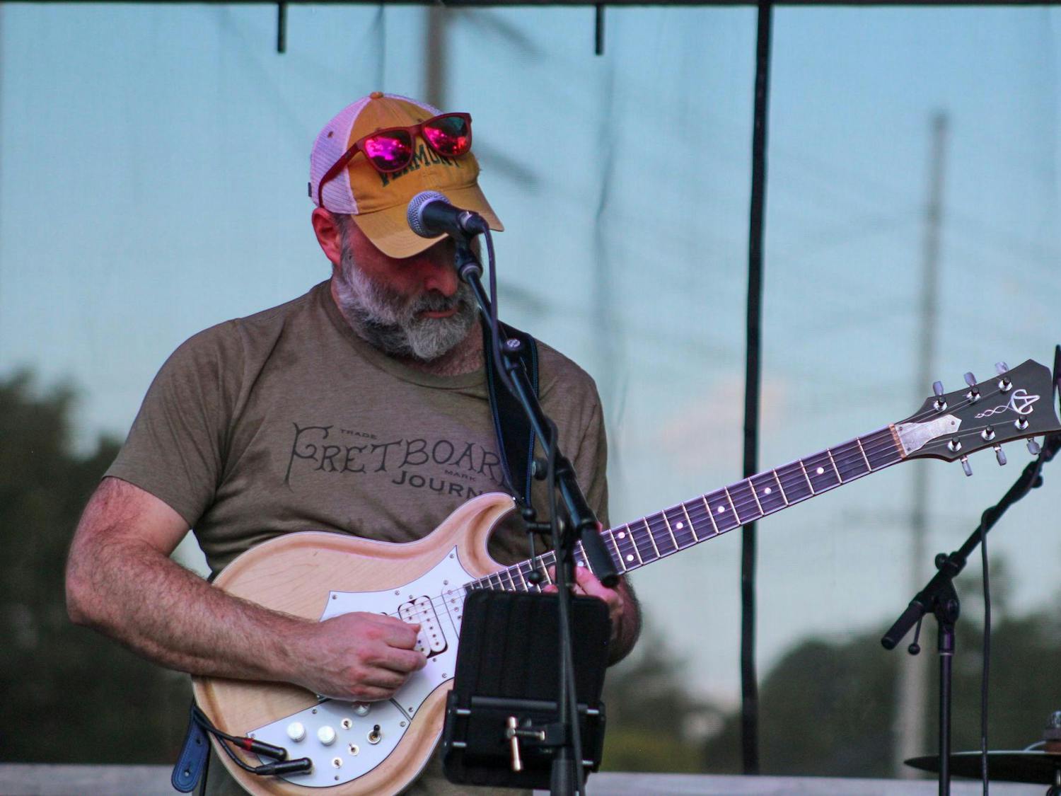 The lead singer of Jerry Garcia Band Cover Band plays guitar on the main stage for attendees at JerryFest on Oct. 6, 2024. Jerry Garcia Band Cover Band was one of many bands performing at JerryFest.
